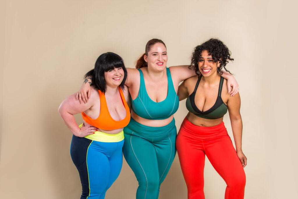 Group of 3 oversize women posing in studio